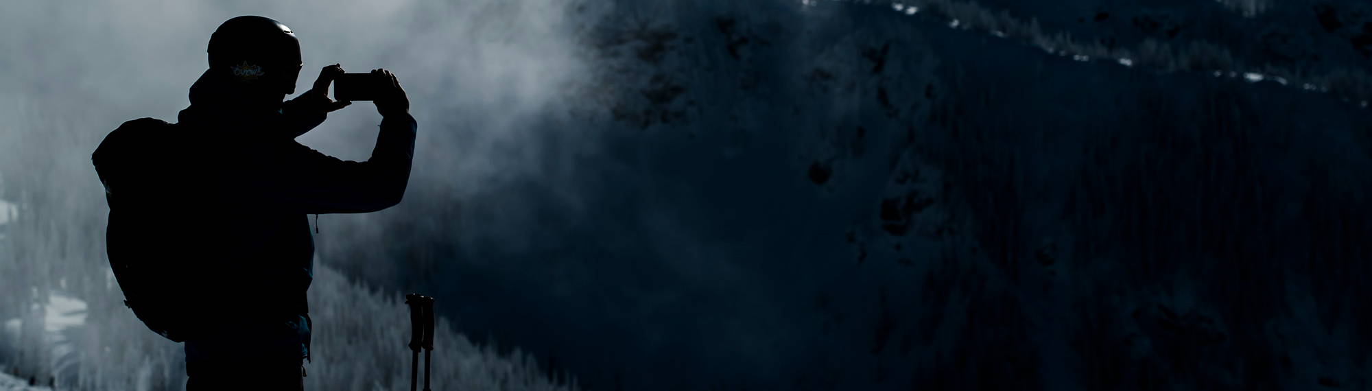 skier taking picture with phone